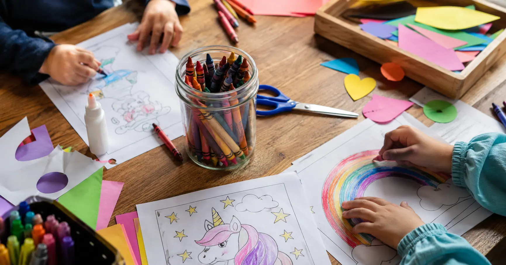 Child coloring at a table with crayons